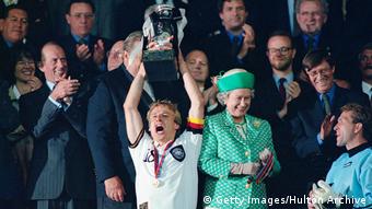 Germany's Jürgen Klinsmann lifts the trophy at Euro '96
