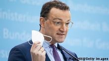 BERLIN, GERMANY - JANUARY 18: Health Minister Jens Spahn holds a protective FPP2 mask as he speaks during a press conference on January 18, 2021 in Berlin, Germany. The laboratories will be obliged to sequence coronavirus samples to monitor virus mutations and labs would be compensated for each genome sequencing they carry out, Spahn said. (Photo by Maja Hitij/Getty Images)