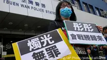 Chow Hang Tung, Vice Chairperson of the Hong Kong Alliance in Support of the Democratic Patriotic Movements of China, holds placards after being released on bail at a police station in Hong Kong, Saturday, June 5, 2021. Hong Kong police on Friday, June 4, arrested Chow for publicizing an unauthorized assembly via social media despite the police ban on the annual June 4 candlelight vigil. The placards read: Innocent of candlelight, Tung Tung will return from victory. (AP Photo/Kin Cheung)