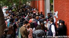 People try to enter to cast their vote minutes before the door closes during mid-term elections in Mexico City , Mexico June 6, 2021. REUTERS/Carlos Jasso