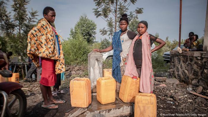 Children line up for water for residents displaced after Mount Nyiragongo erupts on May 29, 2021