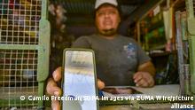 June 7, 2021, Chiltuipan, La Libertad, El Salvador: A man holds a mobile phone displaying an application that shows the price ang graph of Bitcoin..Salvadoran President Nayib Bukele has announced that he will propose a law to the Congress, where his party controls a majority, for Bitcoin to become legal tender. El Salvador would become the first country in the world to accept a cryptocurrency as a legal tender. (Credit Image: © Camilo Freedman/SOPA Images via ZUMA Wire