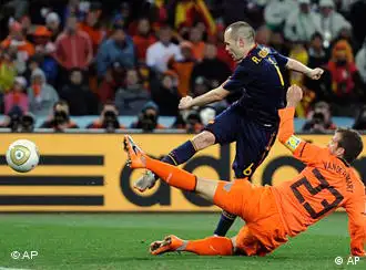 Spain's Andres Iniesta, back, scores a goal past Netherlands' Rafael van der Vaart, front