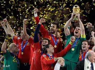Spain goalkeeper Iker Casillas, right, holds up the World Cup trophy