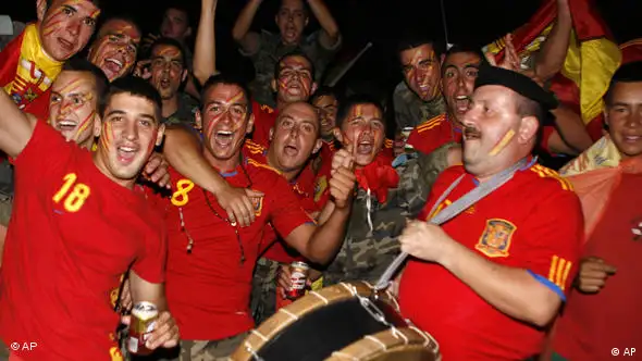 Spanish soldiers serving with the United Nations Interim Force in Lebanon (UNIFIL) cheer as they watch a live broadcast of the World Cup soccer final between Spain and the Netherlands, which is being played in South Africa, at their base in the village of Blatt, near the southern town of Marjayoun, Lebanon, Sunday, July 11, 2010. (AP Photo/Lutfallah Daher)