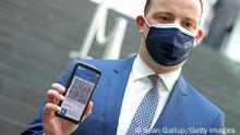 10/06/2021 BERLIN, GERMANY - JUNE 10: German Health Minister Jens Spahn holds up a smartphone with the CovPass Covid vaccination digital certificate on a smartphone through Germany's Corona Warn app on June 10, 2021 in Berlin, Germany. CovPass will provide those who have been fully vaccinated against Covid-19 international certification. Countries across the EU have been working on a common platform for digital vaccination certification in particular to promote international summer travel and tourism. (Photo by Sean Gallup/Getty Images) 