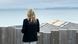 USA First Lady Jill Biden wearing a black jacket with the word 'love' on the back looks out to the see USA First Lady Jill Biden wearing a black jacket with the word 'love' on the back looks out to the see