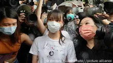 Agnes Chow, center, a prominent pro-democracy activist who was sentenced to jail last year for her role in an unauthorized protest, is released in Hong Kong Saturday, June 12, 2021. Chow rose to prominence as a student leader in the now defunct Scholarism and Demosisto political groups, alongside other outspoken activists such as Joshua Wong and Ivan Lam. (AP Photo/Vincent Yu)