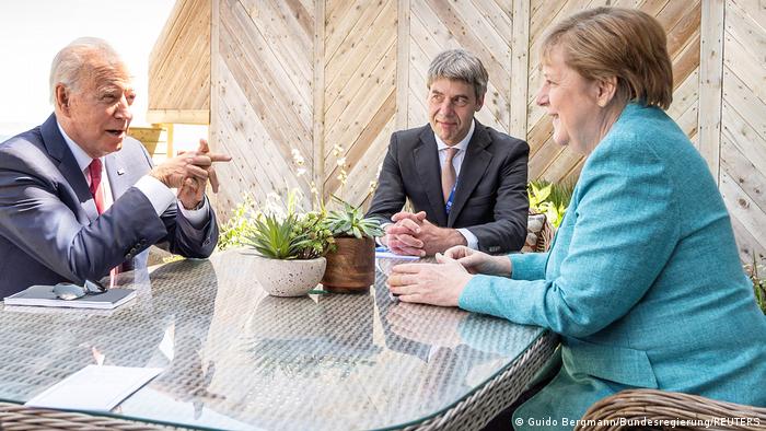 Joe Biden, Angela Merkel and adviser Jan Hecker attend a bilateral meeting during a G7 summit