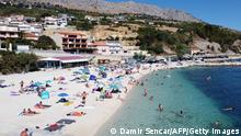 Crowds of people, including foreign tourists, enjoy the sun and the sea on August 21, 2020, in Split on the central Adriatic coast. - As United Kingdom removed Croatia from the list of safe countries to travel due to rising number of cases of COVID-19 throughout the country, many British tourists arrived at airport to return back to their country because of stricter measures when returning from Croatia. (Photo by Damir SENCAR / AFP) (Photo by DAMIR SENCAR/AFP via Getty Images)