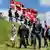 German President Steinmeier walks with Danish flags behind him