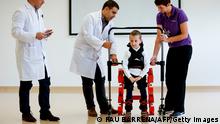 Jens, a 5 years-old boy diagnosed with spinal muscular atrophy (SMA), walks with a new Marsi Bionics exoskeleton designed for children at Sant Joan de Deu Hospital in Barcelona on November 29, 2017. / AFP PHOTO / PAU BARRENA (Photo credit should read PAU BARRENA/AFP via Getty Images)