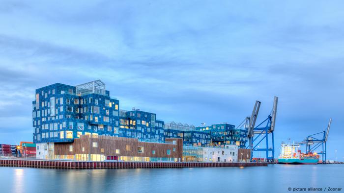 International school in Copenhagen at sunset at the water with solar panels along the front of it