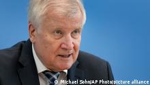German Interior Minister Horst Seehofer addresses the media during a press conference on the 'Constitution Protection Report 2020' in Berlin, Germany, Tuesday, June 15, 2021. (AP Photo/Michael Sohn, pool)
