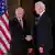 Vladimir Putin shakes hands with Joe Biden