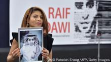 TOPSHOT - Ensaf Haidar holds a picture of her husband Raif Badawi after accepting the European Parliament's Sakharov human rights prize on behalf of her husband, at the European Parliament in Strasbourg, eastern France, on December 16, 2015. Raif Badawi is a Saudi Arabian blogger and author of a website, detained since 2012 on the charge of breaking Saudi technology laws and insulting religious figures. / AFP / PATRICK HERTZOG (Photo credit should read PATRICK HERTZOG/AFP via Getty Images)