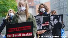 BERLIN, GERMANY - OCTOBER 02: Protesters from Reporters Without Borders, including one holding a sign showing imprisoned Saudi Arabian blogger Raif Badawi, demonstrate outside the Saudi Arabian Embassy on the 2nd anniversary of the murder of Saudi Arabian journalist Jamal Khashoggi on October 02, 2020 in Berlin, Germany. The protesters were demanding the freedom of other journalists and bloggers currently in prison in Saudi Arabia. (Photo by Sean Gallup/Getty Images)