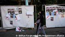 Two women walk past presidential elections candidate Ebrahim Raisi's electoral posters in southern Tehran during the days of Iran's presidential elections campaigns. (Photo by Sobhan Farajvan / Pacific Press)
