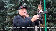 FILE - This Sunday, Aug. 23, 2020 file photo made from video provided by the State TV and Radio Company of Belarus, shows Belarus President Alexander Lukashenko armed with a Kalashnikov-type rifle near the Palace of Independence in Minsk, Belarus. Belarus President Alexander Lukashenko has relied on massive arrests and intimidation tactics to hold on to power despite nearly three months of protests sparked by his re-election to a sixth term, but continuing protests have cast an unprecedented challenge to his 26-year rule. (State TV and Radio Company of Belarus via AP, File)