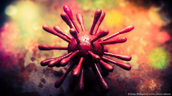 Die Abbildung stellt Viren dar und zeigt einen roten Ball, der ganz aus Nägeln besteht