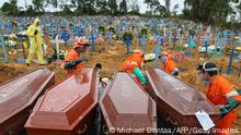 TOPSHOT - Coffins are unloaded to be buried in a mass grave at the Nossa Senhora cemetery in Manaus, Amazon state, Brazil on May 6, 2020. (Photo by MICHAEL DANTAS / AFP) (Photo by MICHAEL DANTAS/AFP via Getty Images)