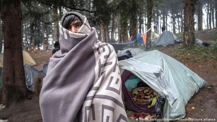 Migrants living in tents shelter from the cold in Bosnia after fleeing Afghanistan