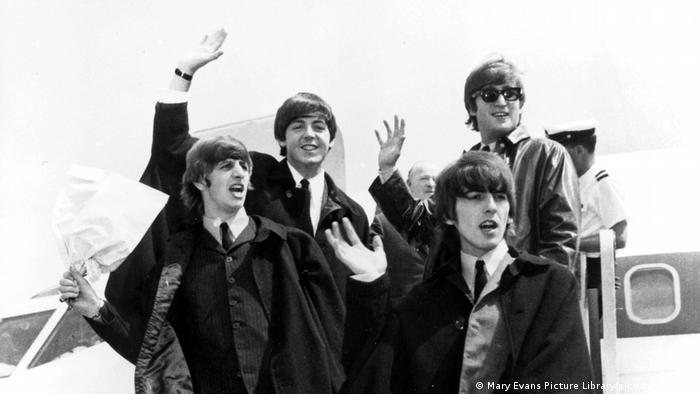 The Beatles waving at the camera