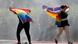 Two people with rainbow flags Two people with rainbow flags