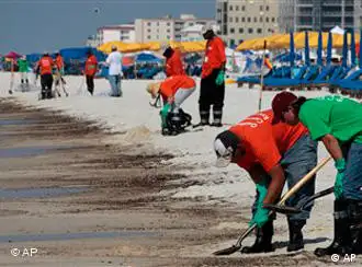 在阿拉巴马州的Orange Beach, BP的工人在清理沙滩