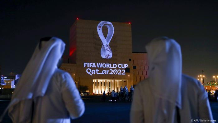 Qataris gather at the capital Doha's traditional Souq Waqif market as the official logo of the FIFA World Cup Qatar 2022 is projected on the front of a building on September 3, 2019.