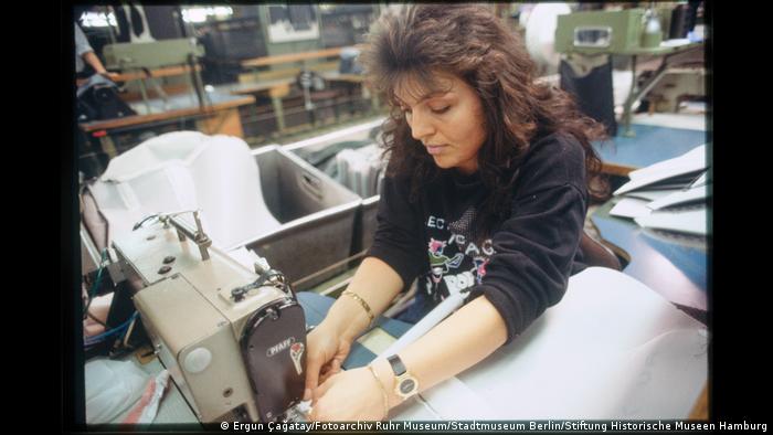 Woman upholstering a car seat. 