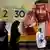 People walk past a banner showing Saudi Crown Prince Mohammed bin Salman, outside a mall in Jeddah.