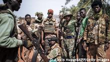 TOPSHOT - Militiamen, including alleged children, of the armed group coalition Coalition of Patriots for Change (CPC) pose for a photograph in the village of Niakari, which marks the front line with the Central African army and its allies, north of Bangassou, on January 30, 2021. - On January 3, 2021, the city of Bangassou was attacked by hundreds of CPC militiamen, causing tens of thousands of people to flee into the bush and neighboring DR Congo. Since the end of December 2020, the rebel coalition has taken control of the main roads and several of the country's major cities. (Photo by ALEXIS HUGUET / AFP) (Photo by ALEXIS HUGUET/AFP via Getty Images)