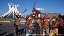 Indigenous march past the Cathedral in Brasilia, Brazil, Wednesday, June 23, 2021. Indigenous activists have traveled to the capital to demand government action to halt illegal mining and logging on their land and oppose a proposed bill they say would limit recognition of tribal lands. (AP Photo/Ricardo Mazalan)