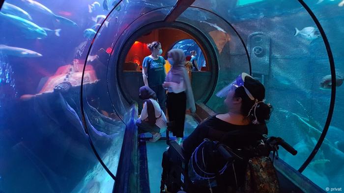 Arwa Abdulhameed looking at fish