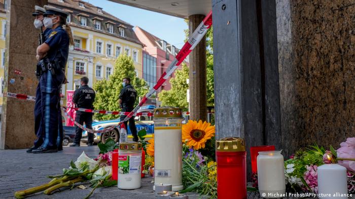 A makeshift memorial of flowers and candles at the site of the June 2021 knife attack in Würzburg, Germany
