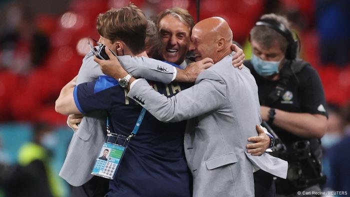 Roberto Mancini (center) celebrates with his staff during Euro 2020