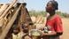 A mother with two of her children holds a bowl of food in the village of Ankilimarovahatsy, Madagascar A mother with two of her children holds a bowl of food in the village of Ankilimarovahatsy, Madagascar