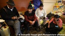 Leonidas Iza, a Quechua leader from mountainous Cotopaxi province, center left, waits for the start of an interview in Quito, Ecuador, Monday, Oct. 14, 2019. Cleanup of the Ecuadorian capital began hours after President Lenín Moreno and indigenous leaders struck a deal late Sunday to cancel a disputed austerity package and end nearly two weeks of protests that paralyzed the Ecuadorian economy and left seven dead. (AP Photo/Fernando Vergara)
