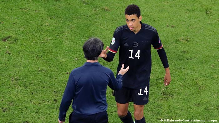Jamal Musiala is congratulated by Germany coach Joachim Löw after the game against Hungary