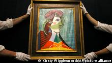 Sotheby's employees adjust a painting by Pablo Picasso called 'Tete de Femme' at the auction rooms in London, Thursday, Jan. 28, 2016. The painting is estimated at 16-20 million pounds (US$23-29 million) when it goes up for auction in London on Feb. 3. in the Impressionist and Modern Art Evening Sale. (AP Photo/Kirsty Wigglesworth)