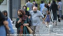 (210628) -- TEHRAN, June 28, 2021 (Xinhua) -- People wearing face masks walk on a street in Tehran, Iran, on June 28, 2021. Iran on Monday reported 12,351 new COVID-19 cases, taking the country's total infections to 3,180,042. (Photo by Ahmad Halabisaz/Xinhua)