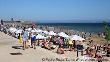 Beachgoers enjoy a summer day at the Carcavelos beach as the COVID-19 coronavirus pandemic continues, in Cascais, near Lisbon, Portugal, on June 26, 2021. (Photo by Pedro FiÃºza/NurPhoto)