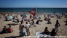 A red flag indicating high beach occupancy is seen at the Carcavelos beach as the COVID-19 coronavirus pandemic continues, in Cascais, near Lisbon, Portugal, on June 26, 2021. (Photo by Pedro FiÃºza/NurPhoto)