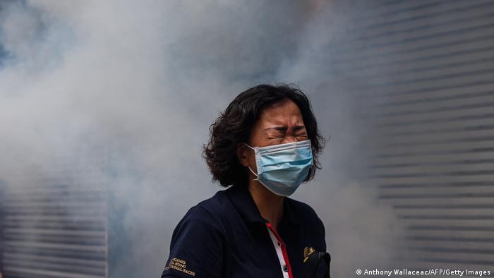 A woman reacts after riot police fired tear gas to disperse protesters taking part in a pro-democracy rally in Hong Kong