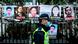 A police officer walks past placards of detained rights activists, including Xu, taped on the fence of the Chinese liaison office in Hong Kong on February 19, 2020 A police officer walks past placards of detained rights activists, including Xu, taped on the fence of the Chinese liaison office in Hong Kong on February 19, 2020