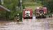 Emergency workers on a flooded street Emergency workers on a flooded street