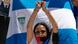 Foto de archivo de una persona que protesta con una bandera de Nicaragua. Foto de archivo de una persona que protesta con una bandera de Nicaragua.