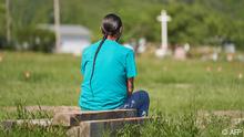 A man man sits and prays at the field where the remains of over 750 children were buried on the site of the former Marieval Indian Residential School in Cowessess First Nation, Saskatchewan, June 25, 2021. - More than 750 unmarked graves have been found near a former Catholic boarding school for indigenous children in western Canada, a tribal leader said Thursday -- the second such shock discovery in less than a month.
The revelation once again cast a spotlight on a dark chapter in Canada's history, and revived calls on the Pope and the Church to apologize for the abuse suffered at the schools, where students were forcibly assimilated into the country's dominant culture. (Photo by Geoff Robins / AFP)