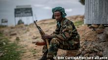 FILE - In this Friday, May 7, 2021 file photo, a fighter loyal to the Tigray People's Liberation Front (TPLF) mans a guard post on the outskirts of the town of Hawzen, then-controlled by the group but later re-taken by government forces, in the Tigray region of northern Ethiopia. The Tigray forces that in late June 2021 have retaken key areas after fierce fighting have rejected the cease-fire and vowed to chase out Ethiopian government forces and those of neighboring Eritrea. (AP Photo/Ben Curtis, File)